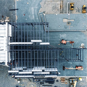 Ariel view of college building being framed on campus