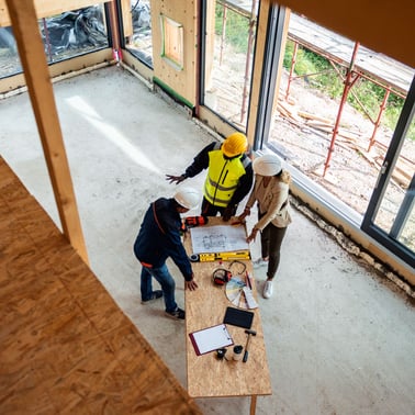 SAFEbuilt building inspector discusses with development team in house under construction