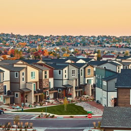 Suburban two-story home community during autumn with trees changing leaves