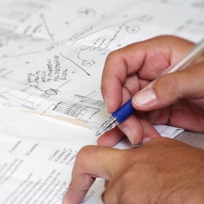 SAFEbuilt plan reviewer hands makes notes on paper