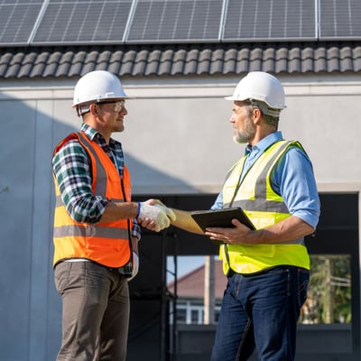 Construction job site employees shaking hands