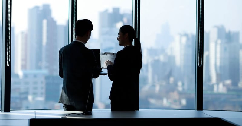 Two municipal employees talking by the window