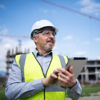 Employee using tablet at construction job site