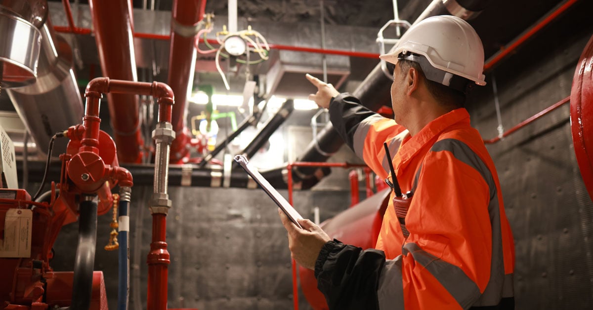 Engineer inspecting fire safety equipment