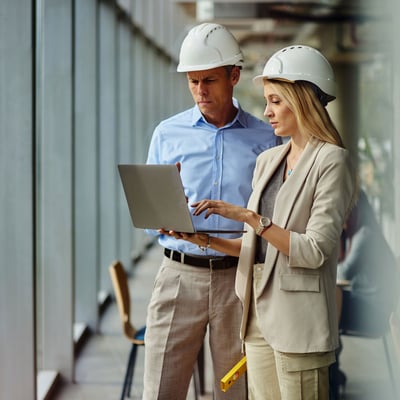 Officials reviewing laptop in hard hats
