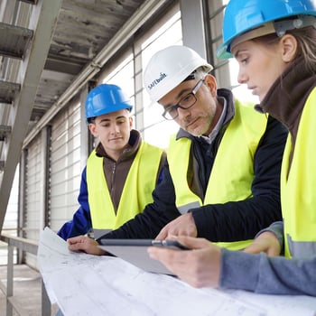 Site manager reviewing tablet at job site