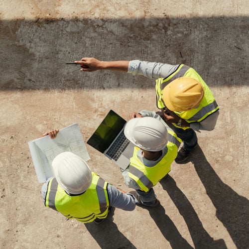 Construction team reviewing a work site. 