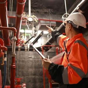 Engineer inspecting fire safety equipment