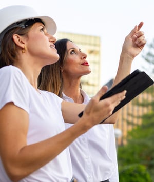 officials reviewing tablet outside
