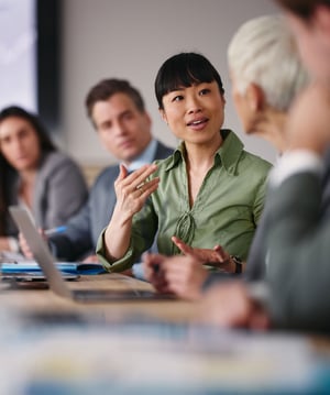 Asian businesswoman talking to colleagues in office