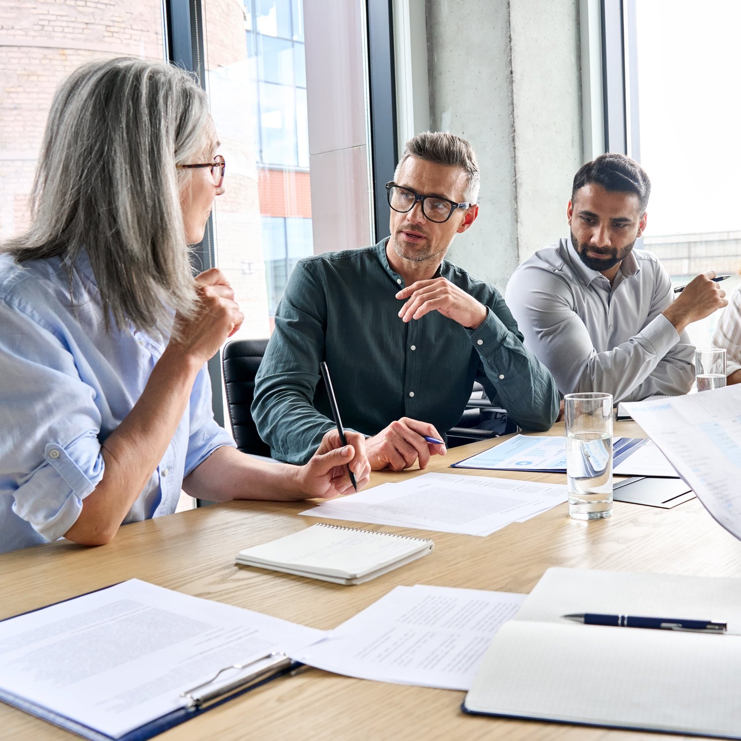 Diverse executives in discussion Diverse executives in discussion