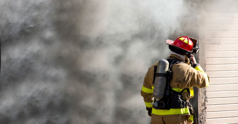 Firefighter outside of smokey building