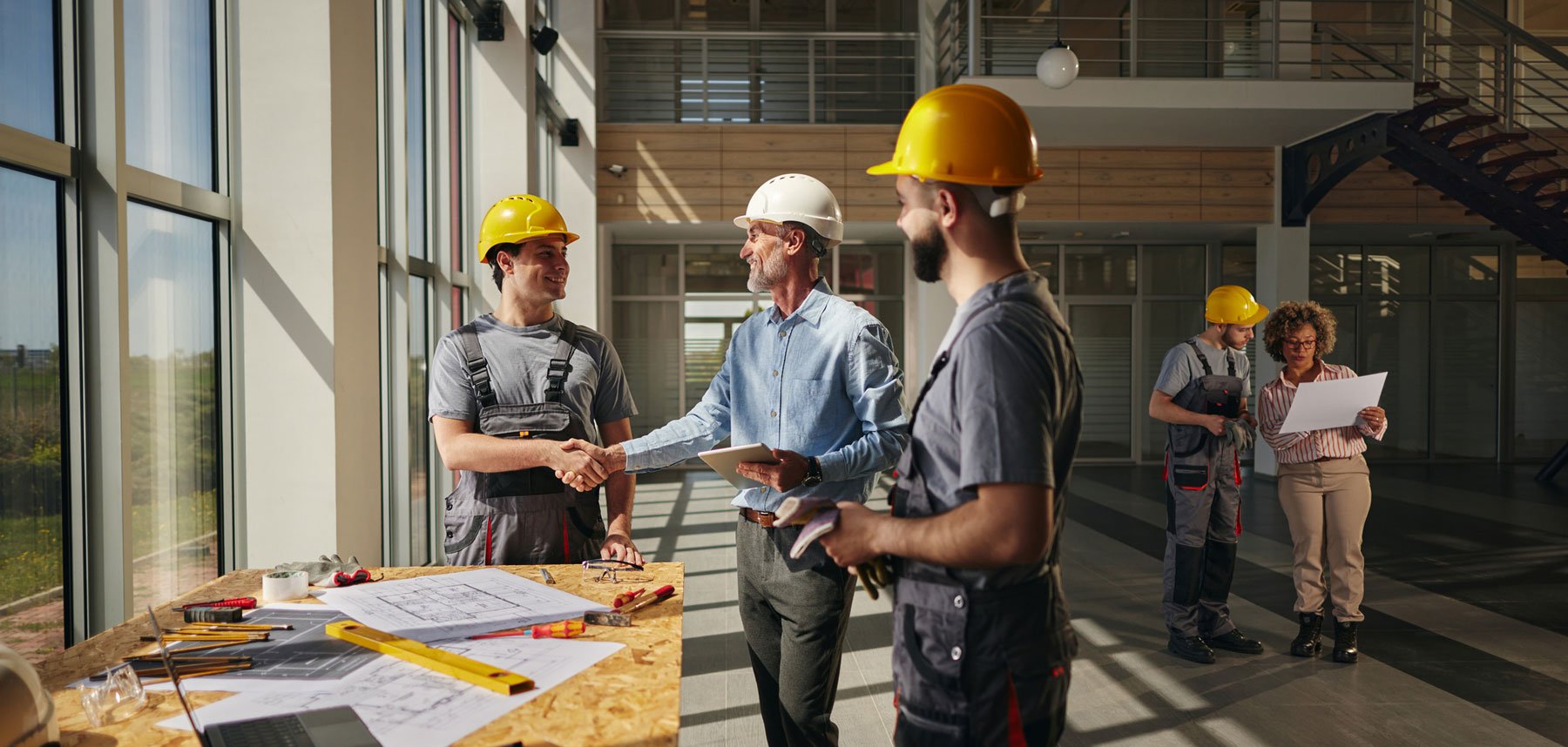 happy-construction-crew-shaking-hands