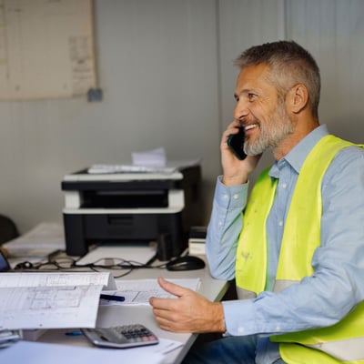 city-worker-at-desk-on-phone-blog
