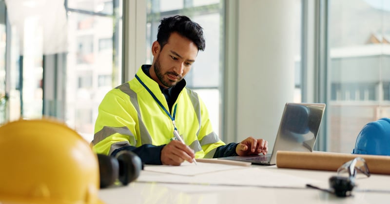 Man reviewing plans at desk