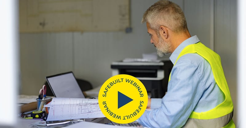 Man reviewing plans at desk