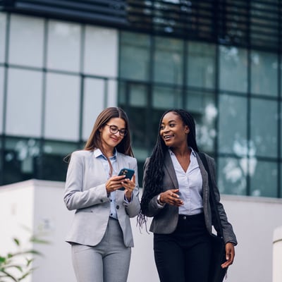 Two female officials walking outside