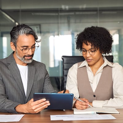 Two officials looking over tablet