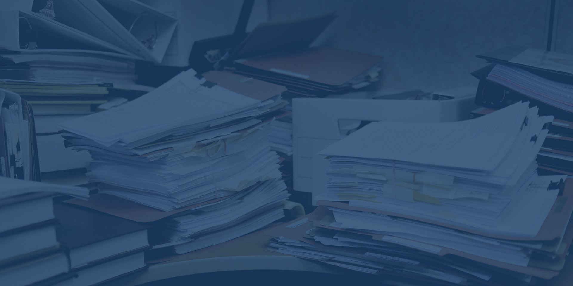cluttered-papers-on-desk