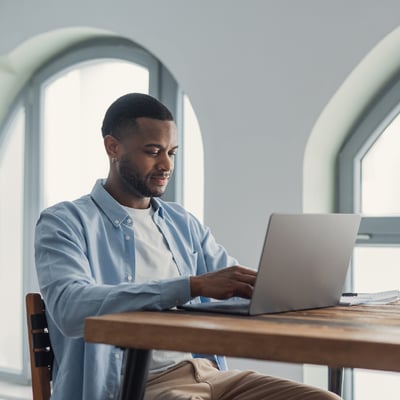 man-sitting-at-laptop-reviewing-permit-information