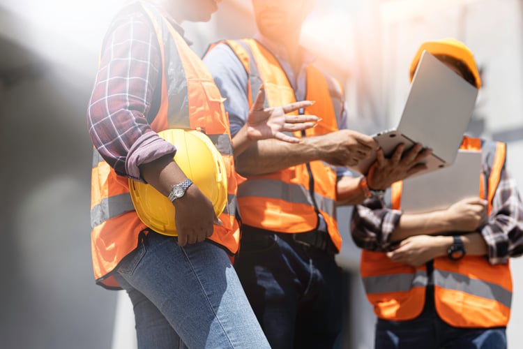 Construction employees standing at job site