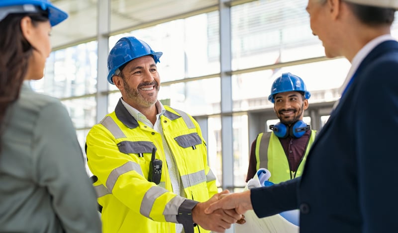 Men on construction site shaking hands