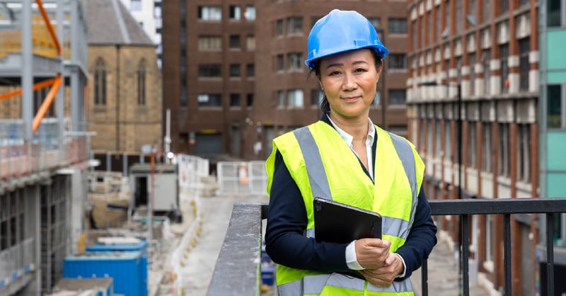 Construction admin worker with a tablet at a work site. 